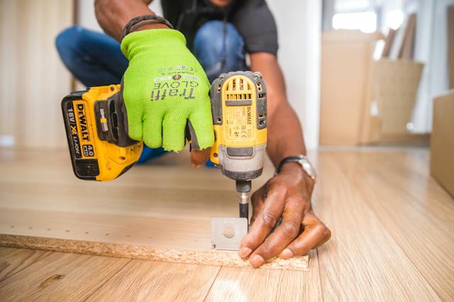 a worker using a screwdriver to repair things in the house